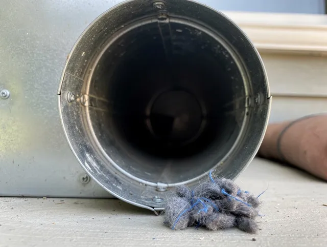 Coconut Creek Dryer Vent Cleaning technician using specialized equipment to clear severe dryer vent blockage in Coconut Creek